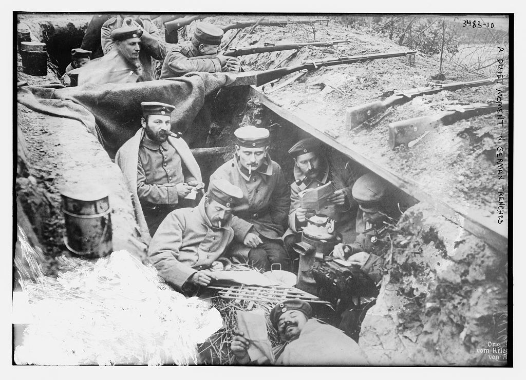 German soldiers reading and smoking in a trench in Flanders